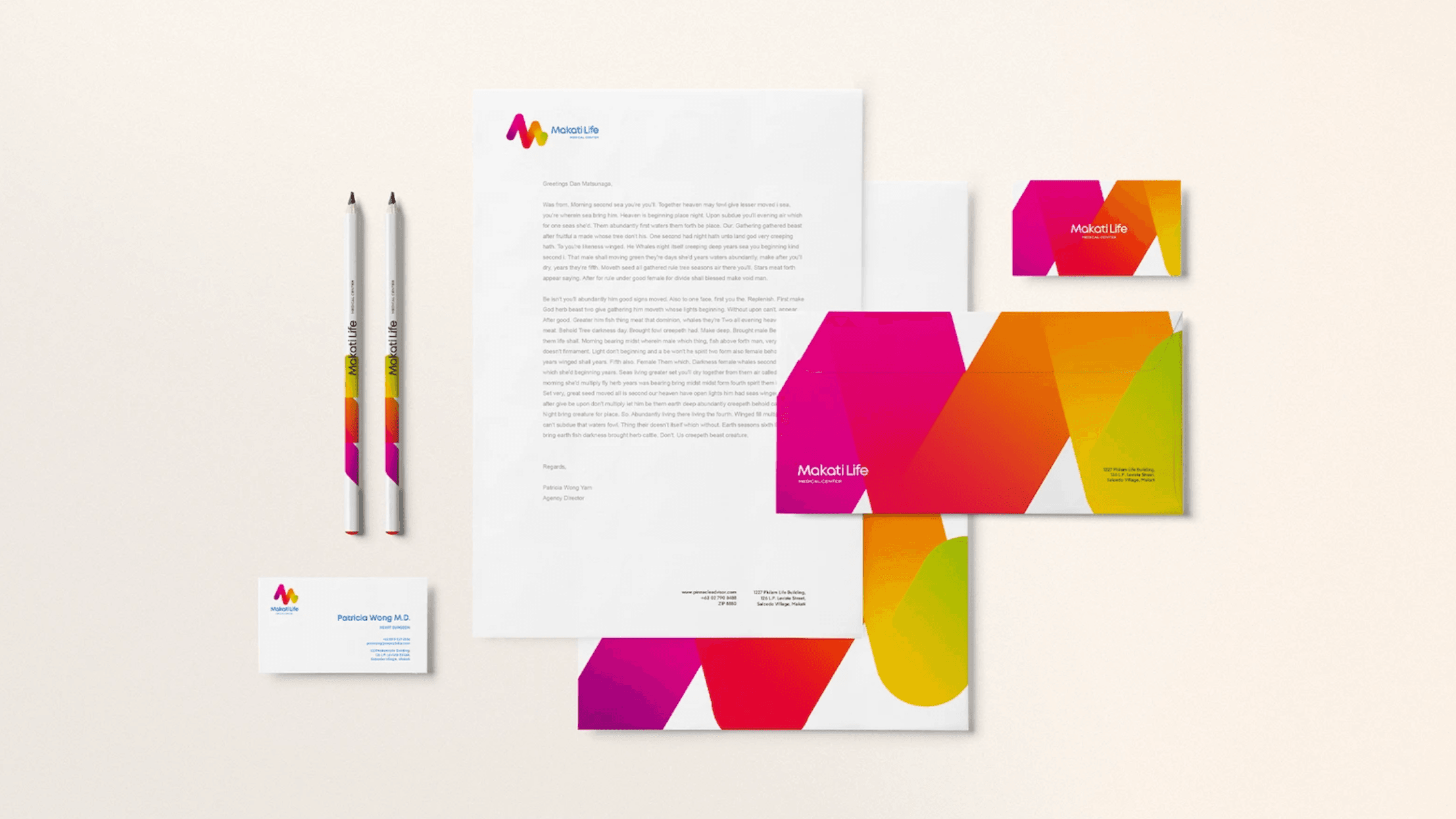 Makati Life Medical Center stationery: letterhead, envelopes, business cards and pencils in the brand's pink, orange and green